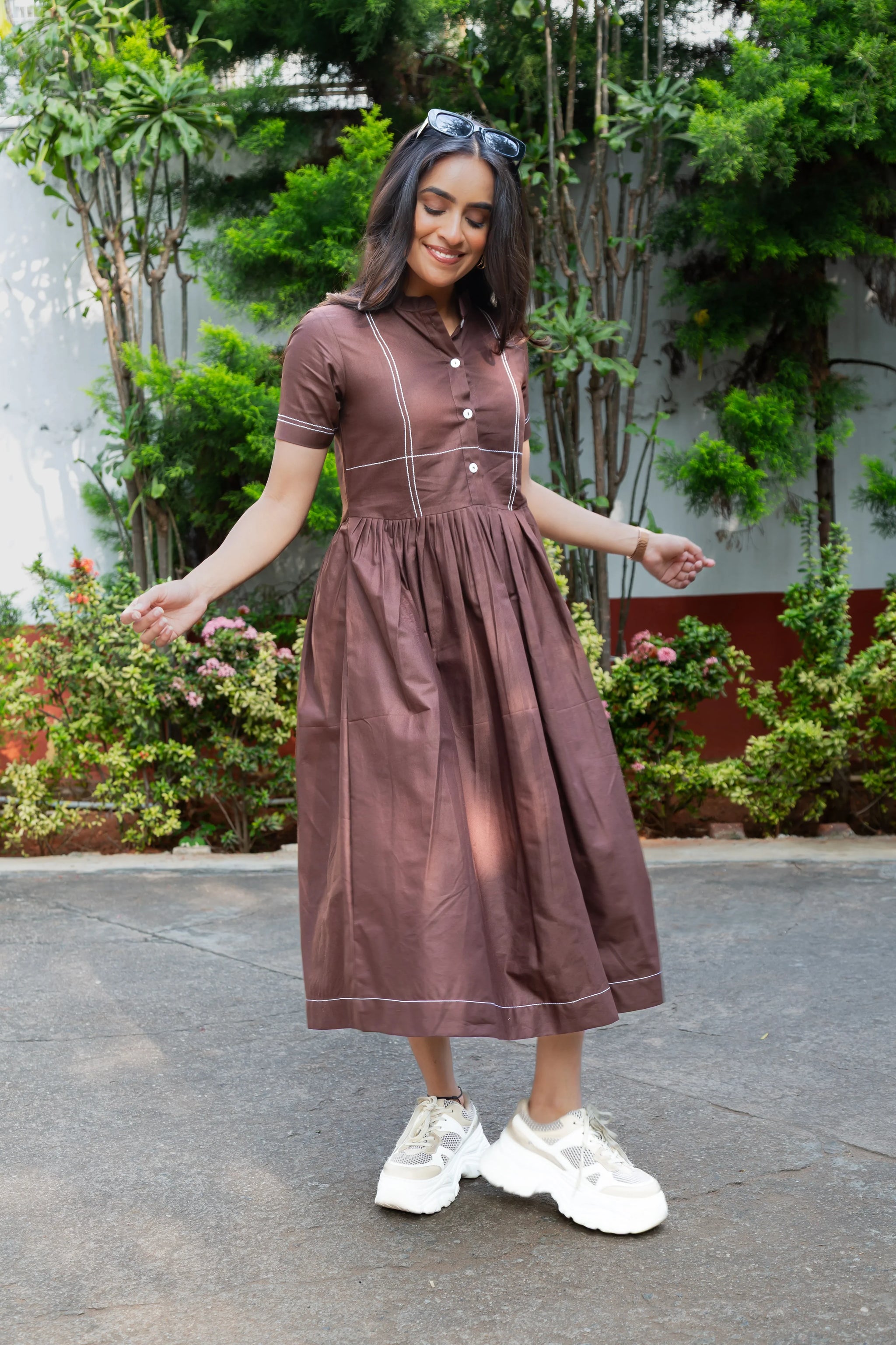 Brown midi dress with white trim, paired with white sneakers, perfect for casual outings