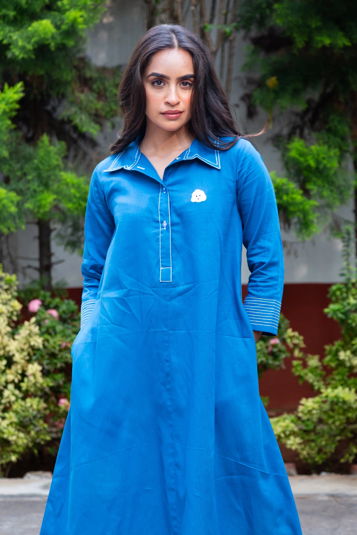 Blue long-sleeve dress with white embroidery and cloud detail, perfect for everyday wear