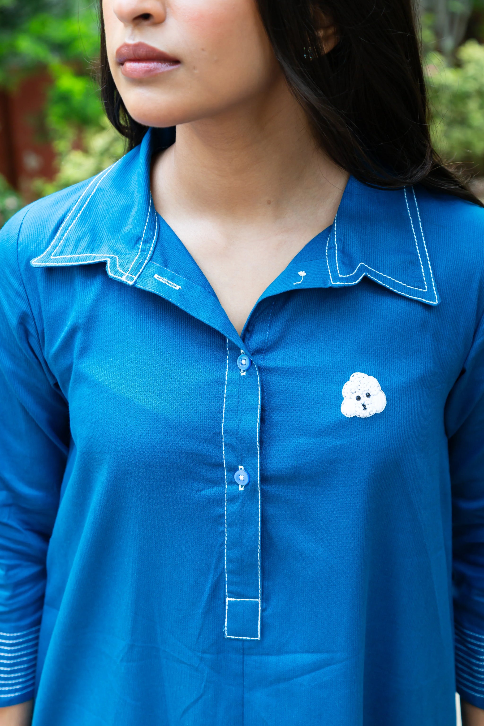 Blue shirt with white dog embroidery and contrast stitching for women's everyday style