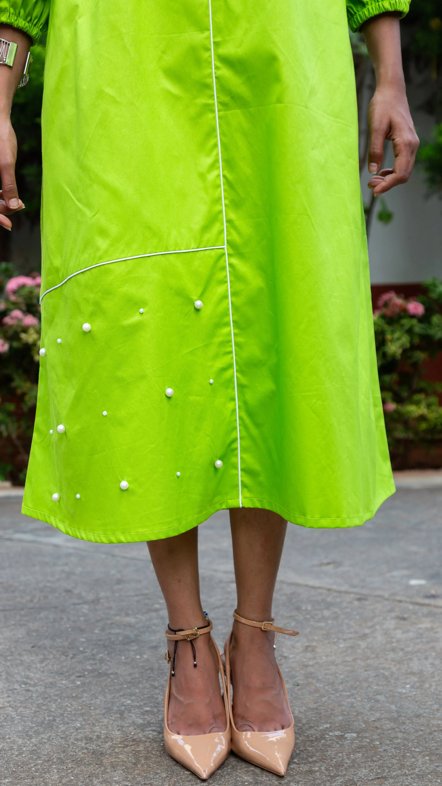 Vibrant green dress with pearl embellishments and beige heels for trendy women's fashion