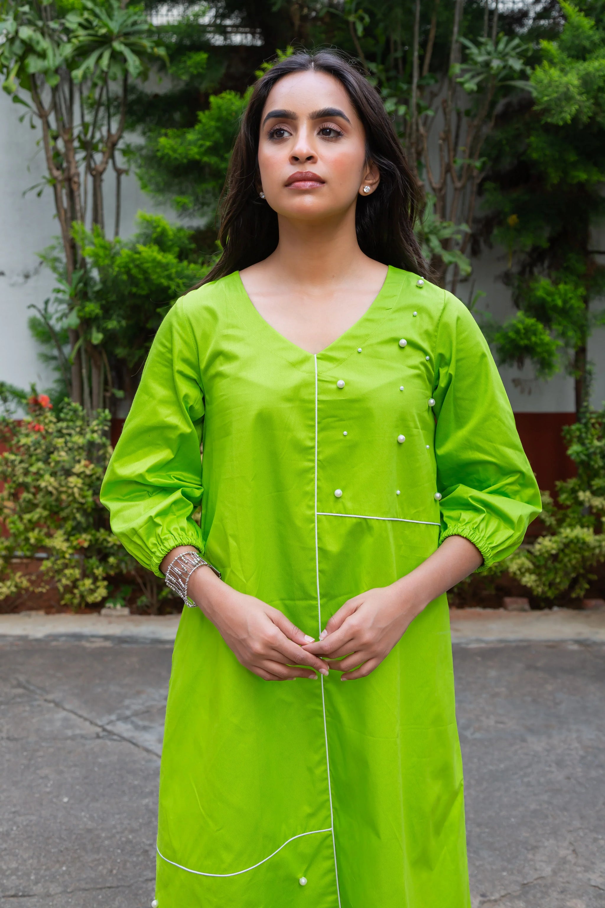 Vibrant green dress with pearl embellishments and white piping, perfect for everyday wear