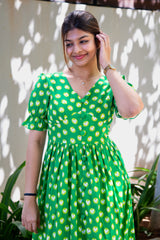 Green heart-print dress with puff sleeves and button front, perfect for trendy everyday wear
