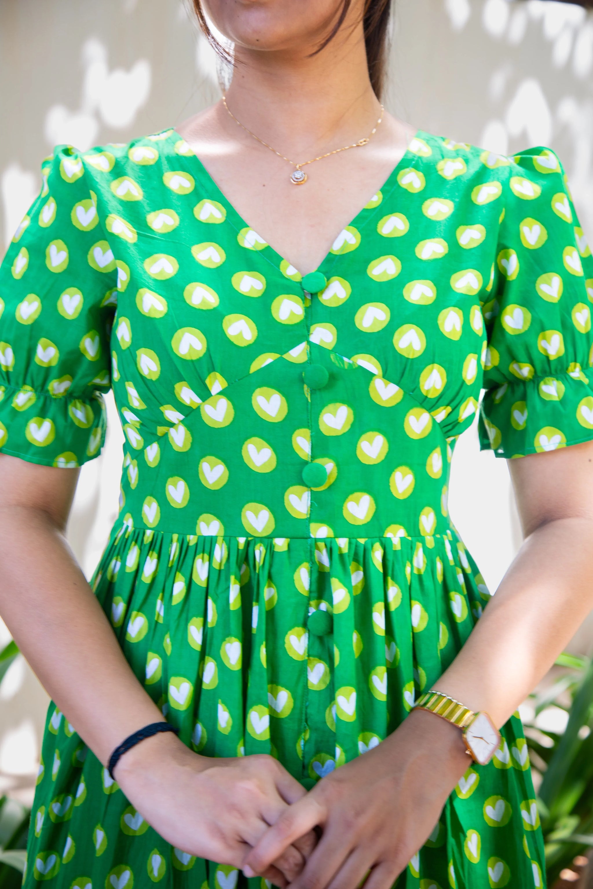 Green heart print dress with puff sleeves and button front, perfect for everyday wear