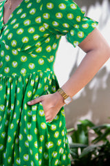 Green dress with white heart print, ruffled sleeves, and gold watch for women's fashion
