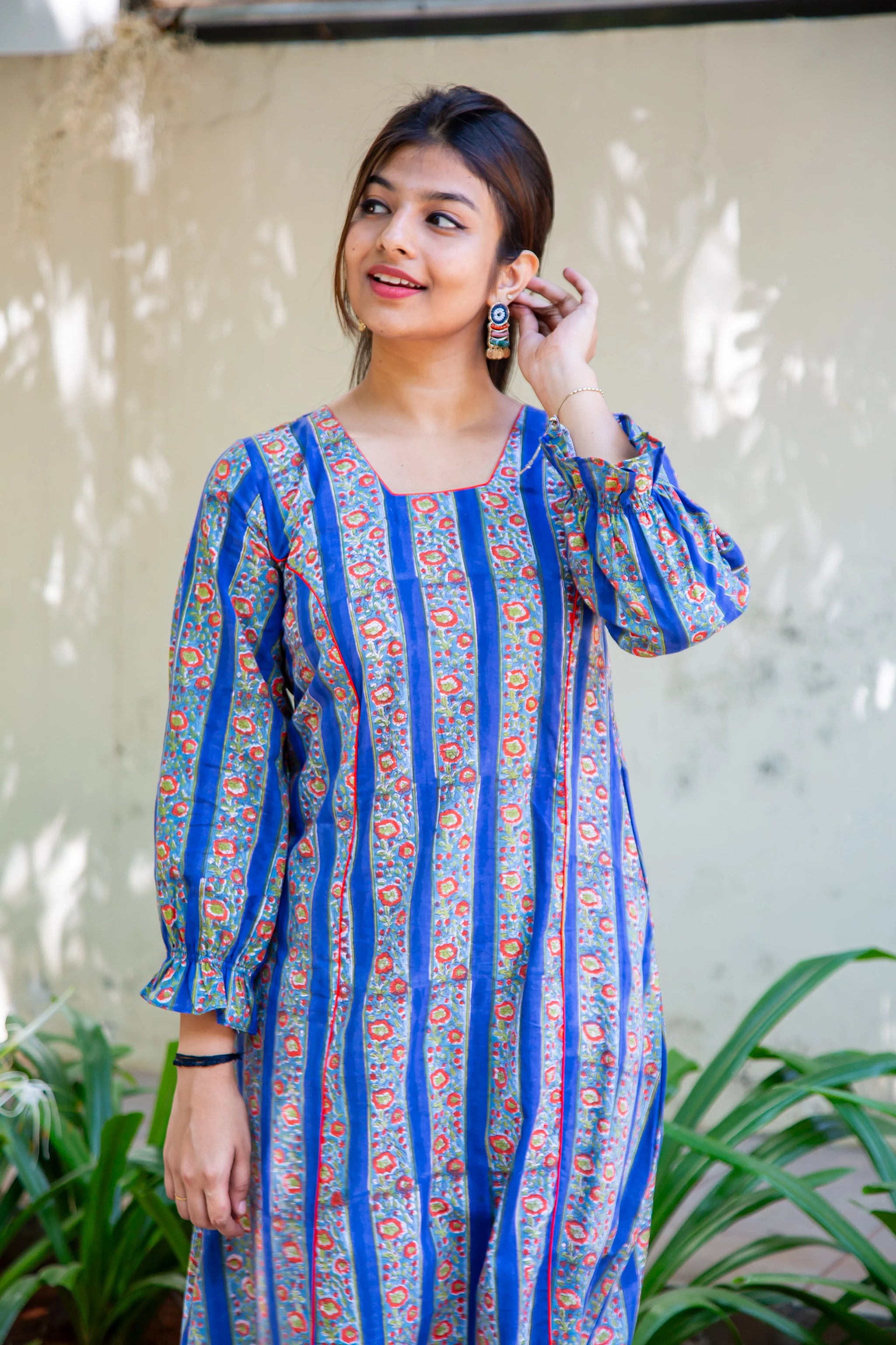 Woman in blue floral print dress with puff sleeves, stylish everyday wear for women