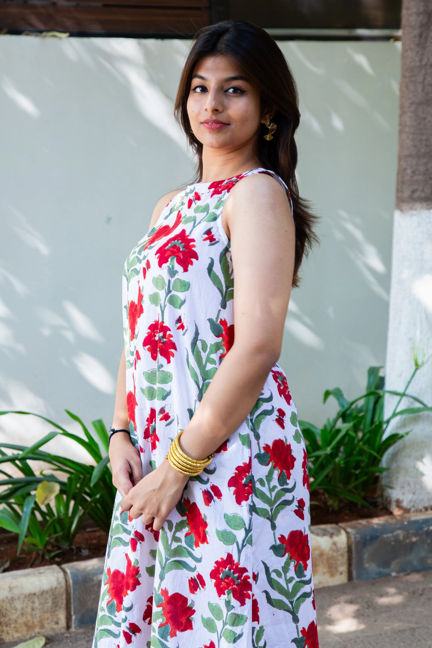 White dress with red floral print, sleeveless design, perfect for casual summer wear
