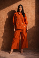 Orange embroidered co-ord set with wide-leg pants and button-up top, styled for everyday wear