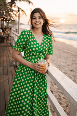 Green heart-print dress at beachside café, perfect for summer outings and casual wear