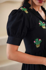 Black cotton dress with puff sleeves and green cactus embroidery detail